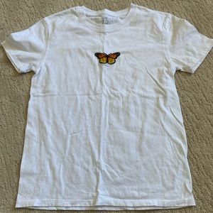 White t shirt with orange and yellow butterfly